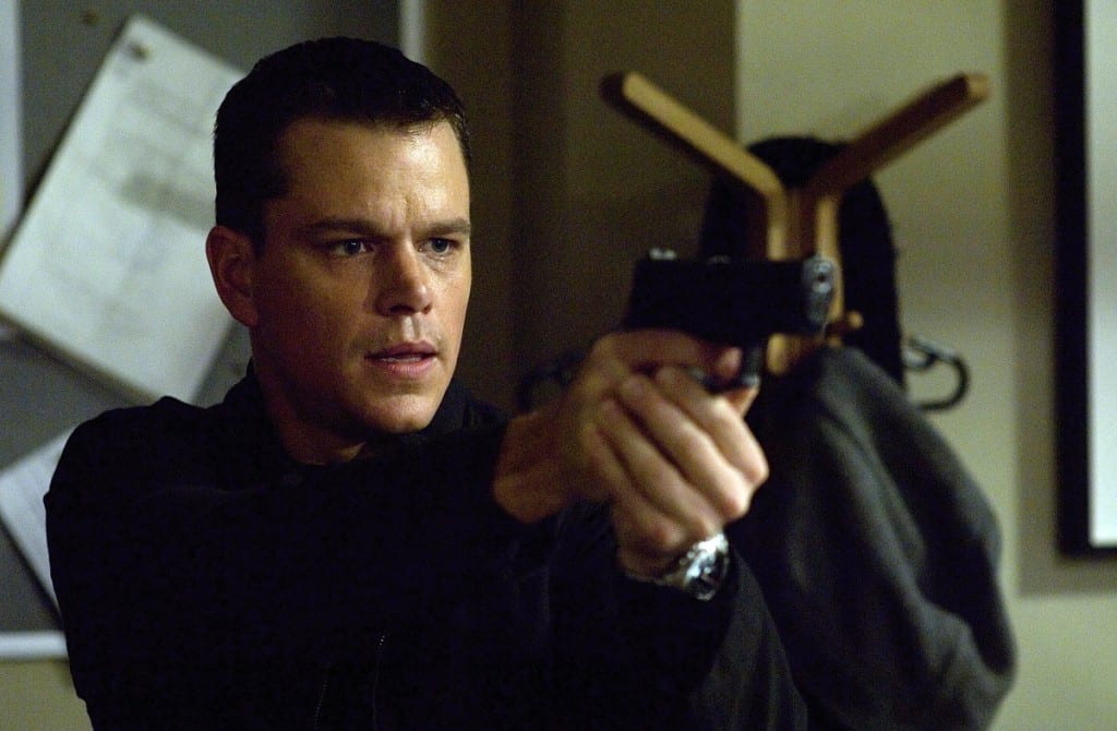 Jason Bourne pointing a handgun.