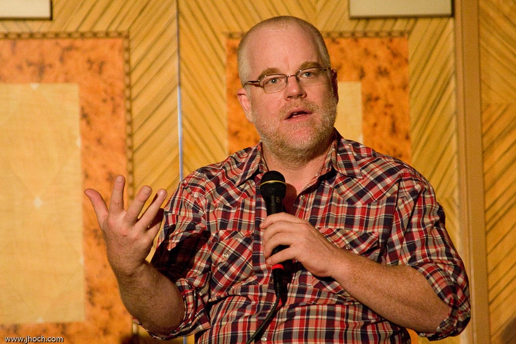 Philip Seymour Hoffman at a press conference holding a microphone