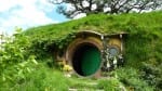 A house with a round door built into the side of a hill on the set of The Lord of the Rings