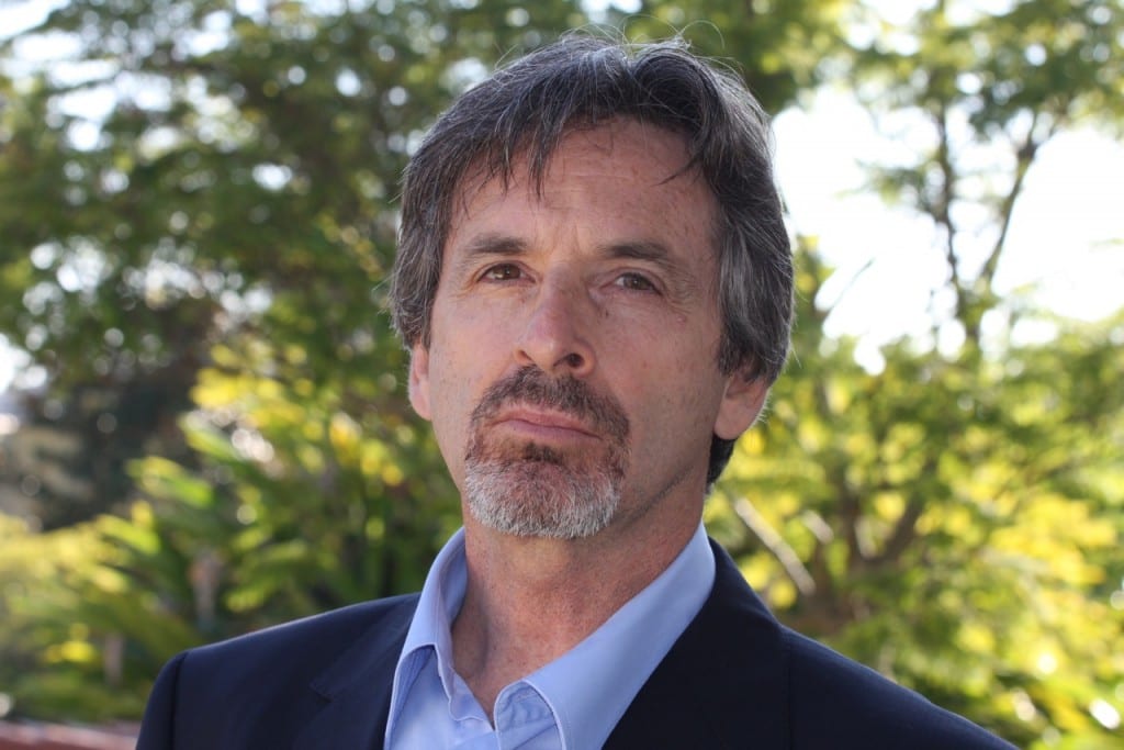 The actor Robert Carradine stood in a forest.