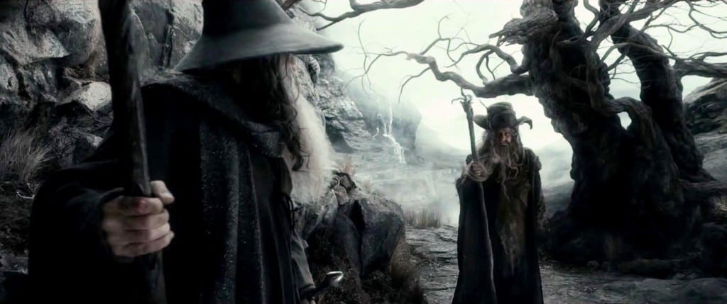 Gandalf and Radagast talking next to a tree.